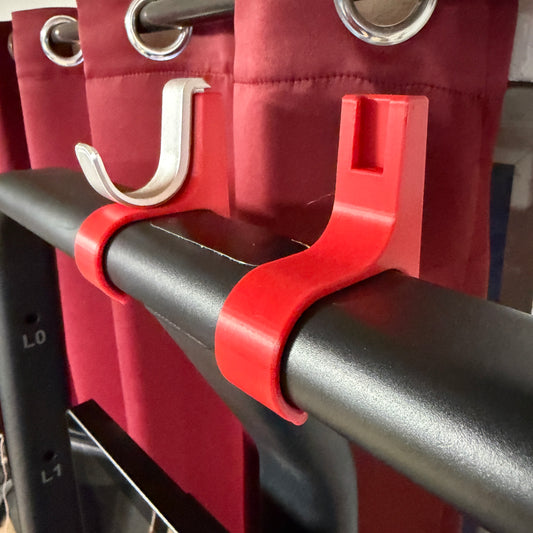 Red and black pull-up bar attachment on a red exercise machine.